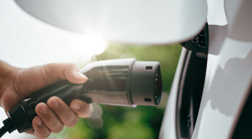 A photo of electric vehicle being plugged in