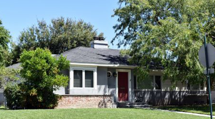 A photo of trees covering home during summer